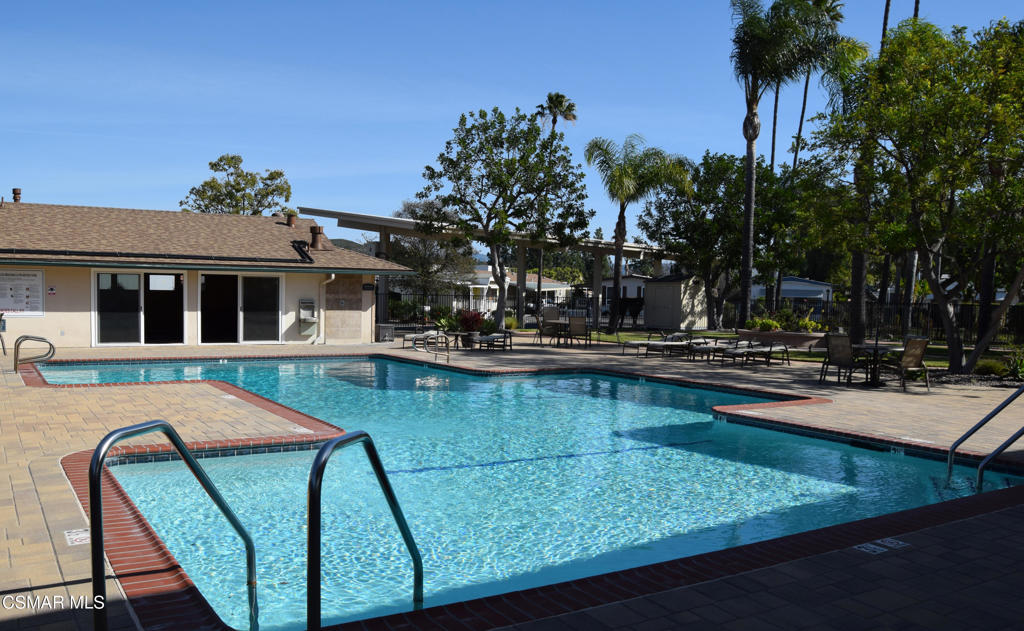 195 Tierra Rejada Road, Unit 197 Simi Valley, CA 93065 - Photo 22 of 28 a view of a swimming pool with a lounge chairs