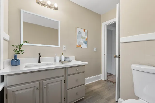 a bathroom with a toilet sink and mirror