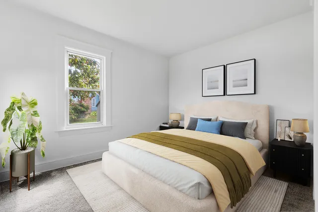 a bedroom with a bed and a window