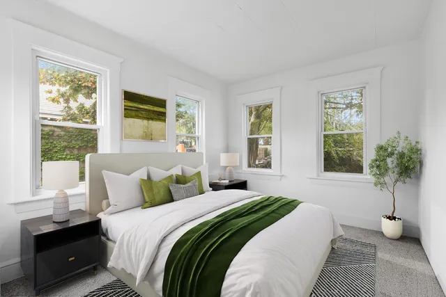 a bedroom with a bed and a window