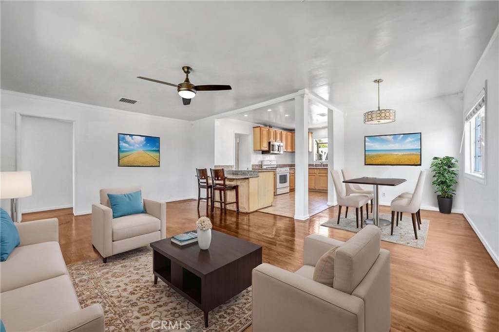 6225 Langdon Avenue Van Nuys, CA 91411 - Photo 2 of 15 a living room with furniture a rug and a chandelier