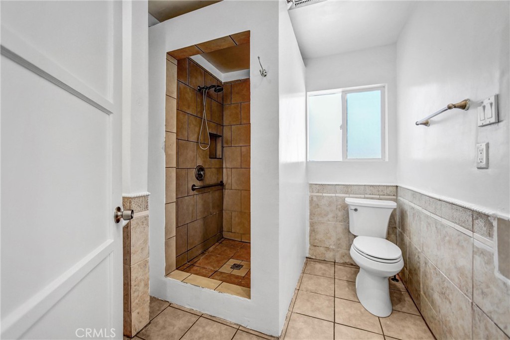 6225 Langdon Avenue Van Nuys, CA 91411 - Photo 6 of 15 a bathroom with a glass door shower
