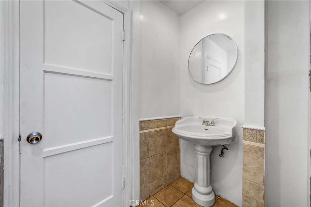 6225 Langdon Avenue Van Nuys, CA 91411 - Photo 7 of 15 a bathroom with a sink a toilet and a mirror