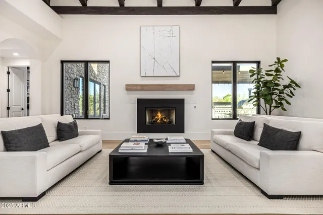 a spacious bedroom with a bed and a chandelier