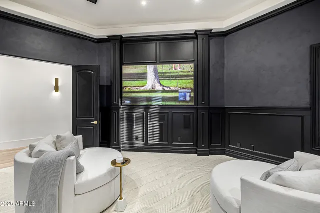 a spacious bedroom with a bed and a chandelier