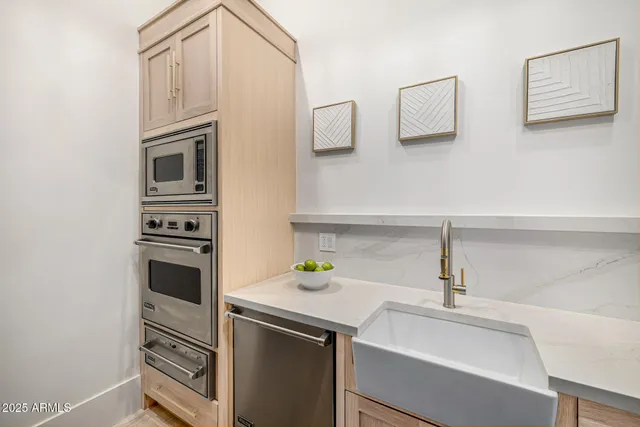 a kitchen with a refrigerator a stove top oven a sink and dishwasher