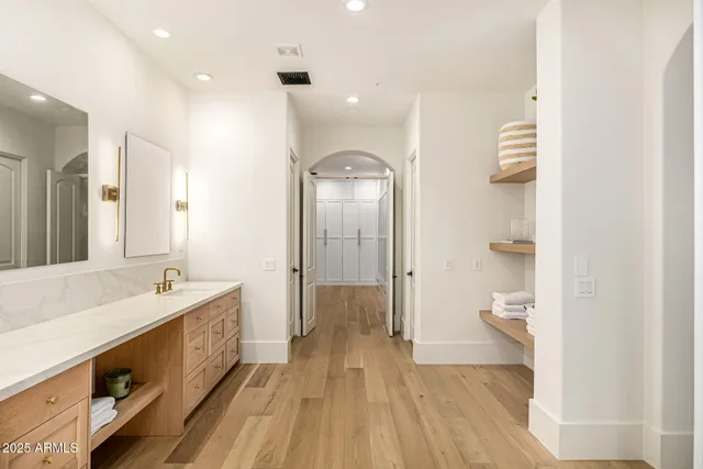 a view of a house with a yard and a car park