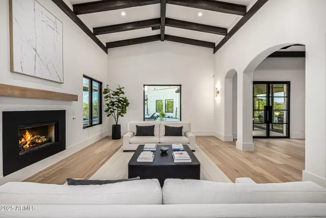 a kitchen with a table chairs refrigerator and cabinets