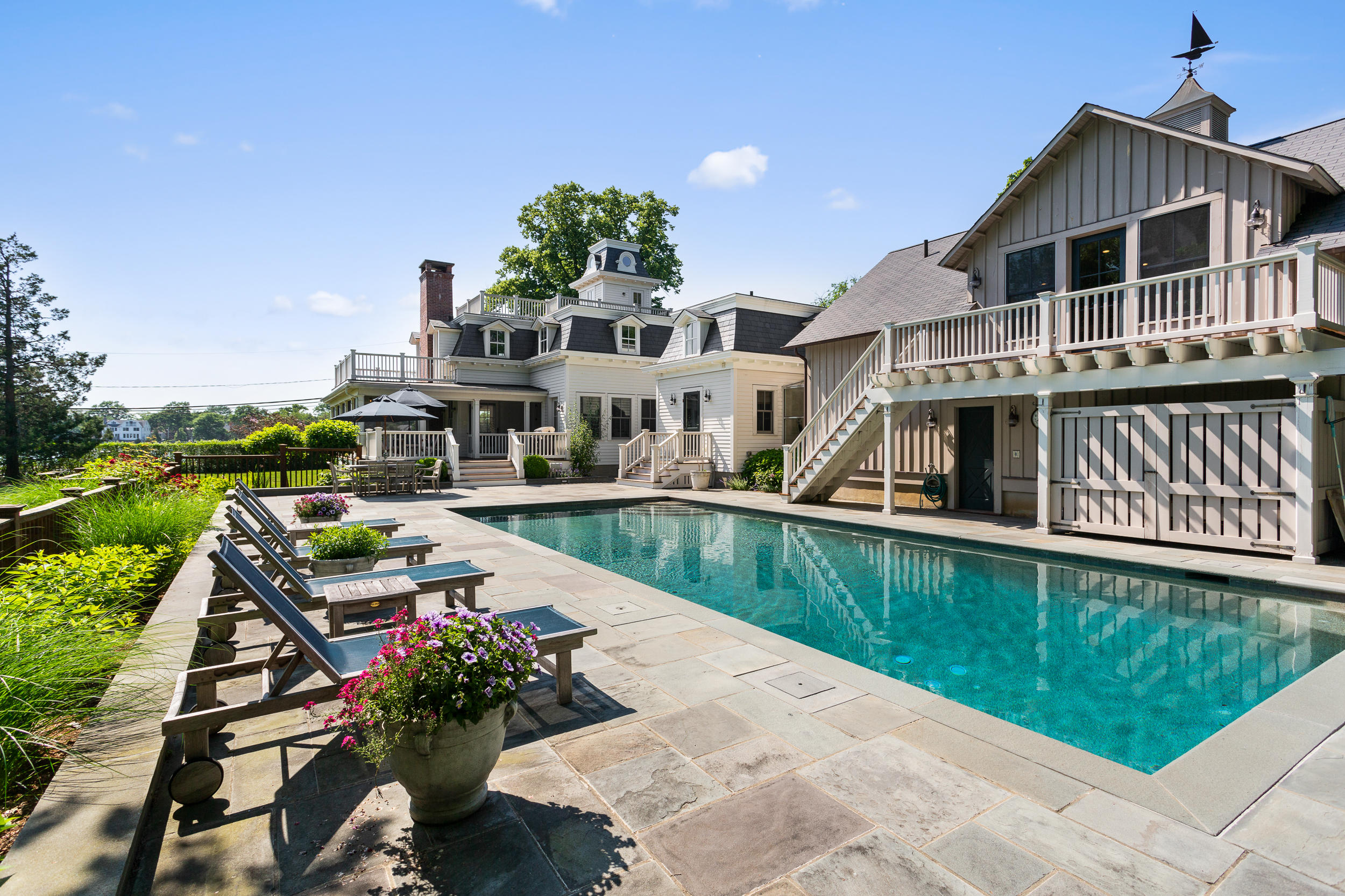 a view of a house with pool and garden view