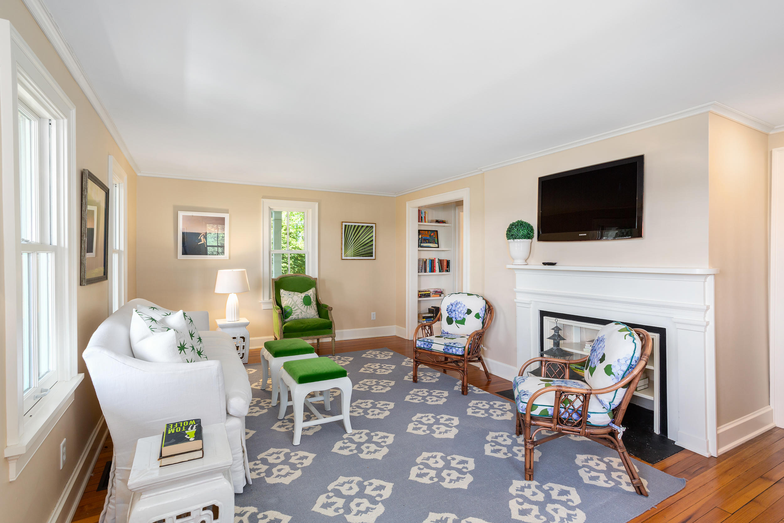 136 Pear Tree Point Road Darien, CT 06820 - Photo 12 of 56 a living room with furniture a flat screen tv and a fireplace