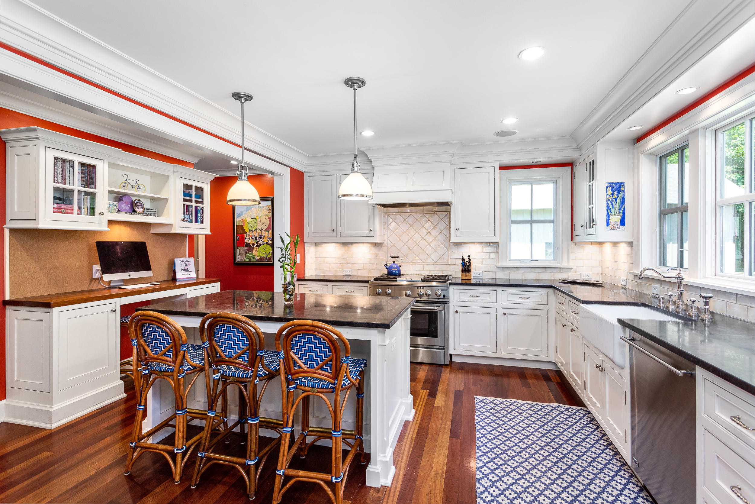 136 Pear Tree Point Road Darien, CT 06820 - Photo 15 of 56 a kitchen with stainless steel appliances granite countertop a stove top oven a sink a dining table and chairs with wooden floor