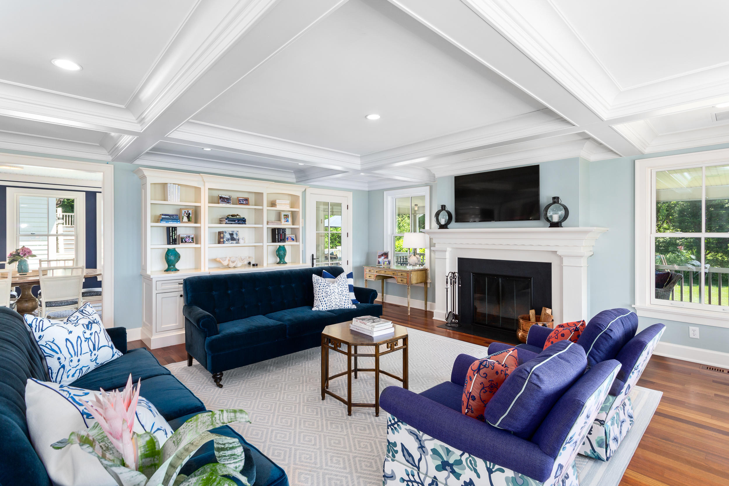136 Pear Tree Point Road Darien, CT 06820 - Photo 19 of 56 a living room with furniture a flat screen tv and a fireplace