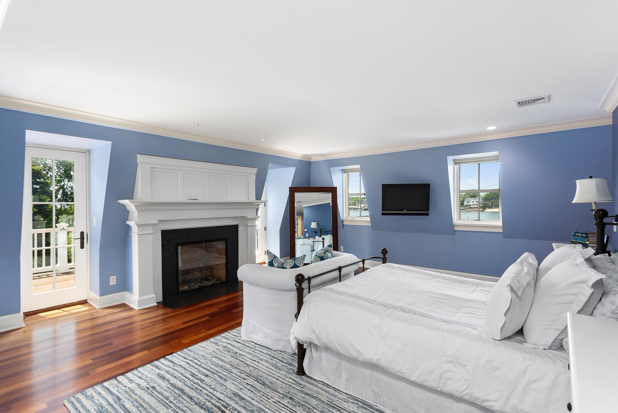 136 Pear Tree Point Road Darien, CT 06820 - Photo 25 of 56 a bedroom with a bed and a fireplace