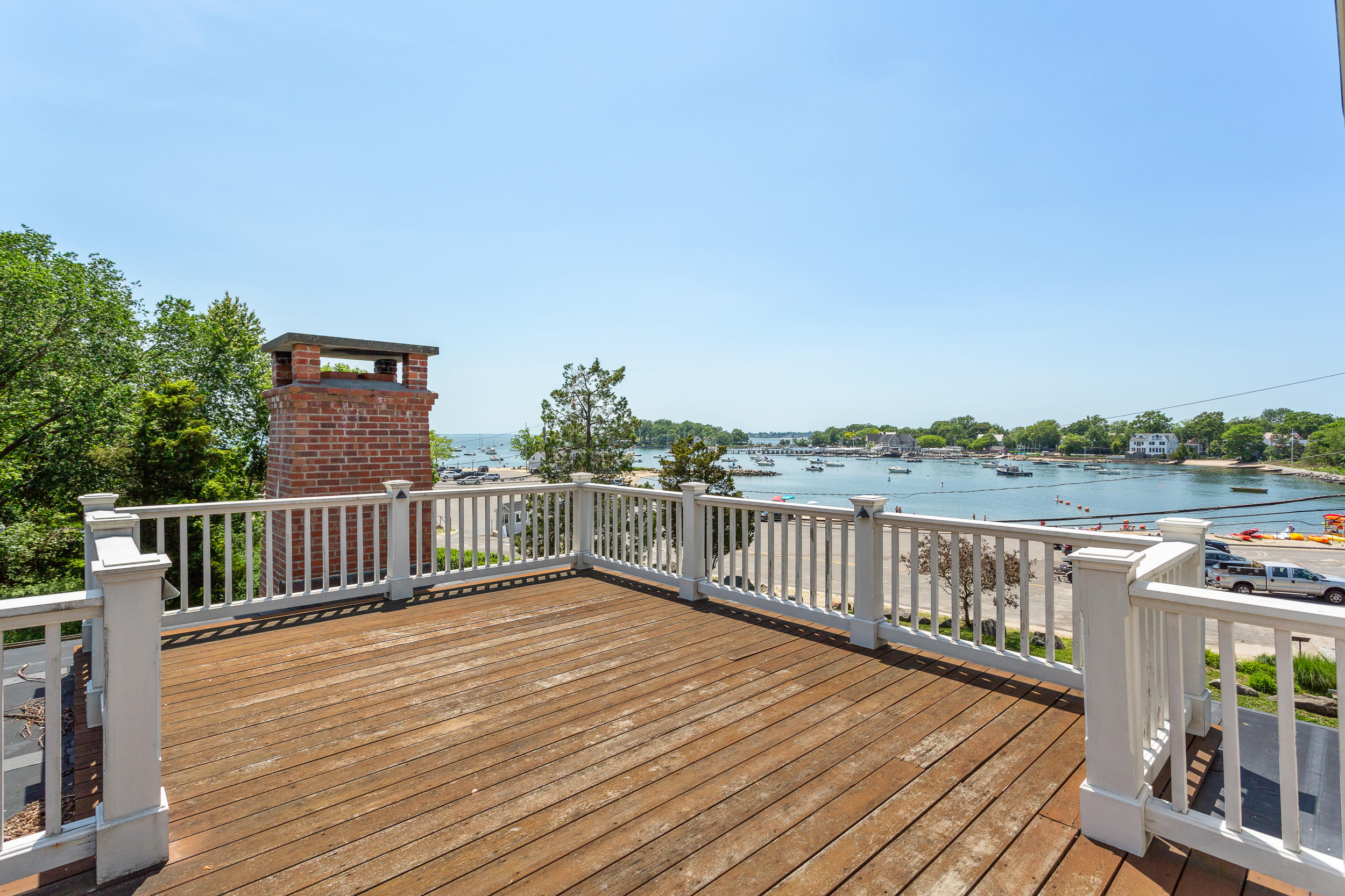 136 Pear Tree Point Road Darien, CT 06820 - Photo 29 of 56 a balcony with wooden floor and fence