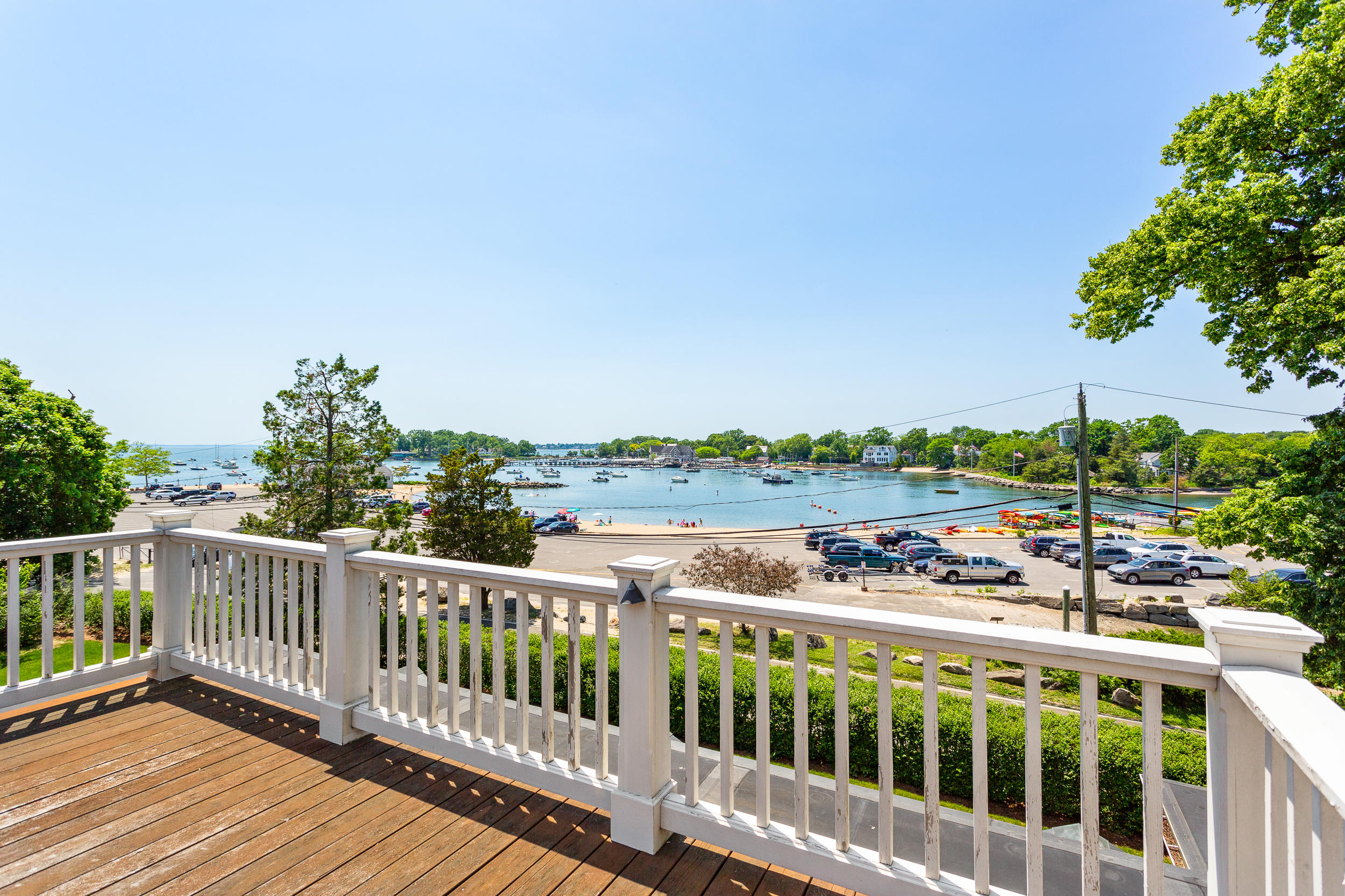 136 Pear Tree Point Road Darien, CT 06820 - Photo 30 of 56 a view of a balcony with wooden floor and fence