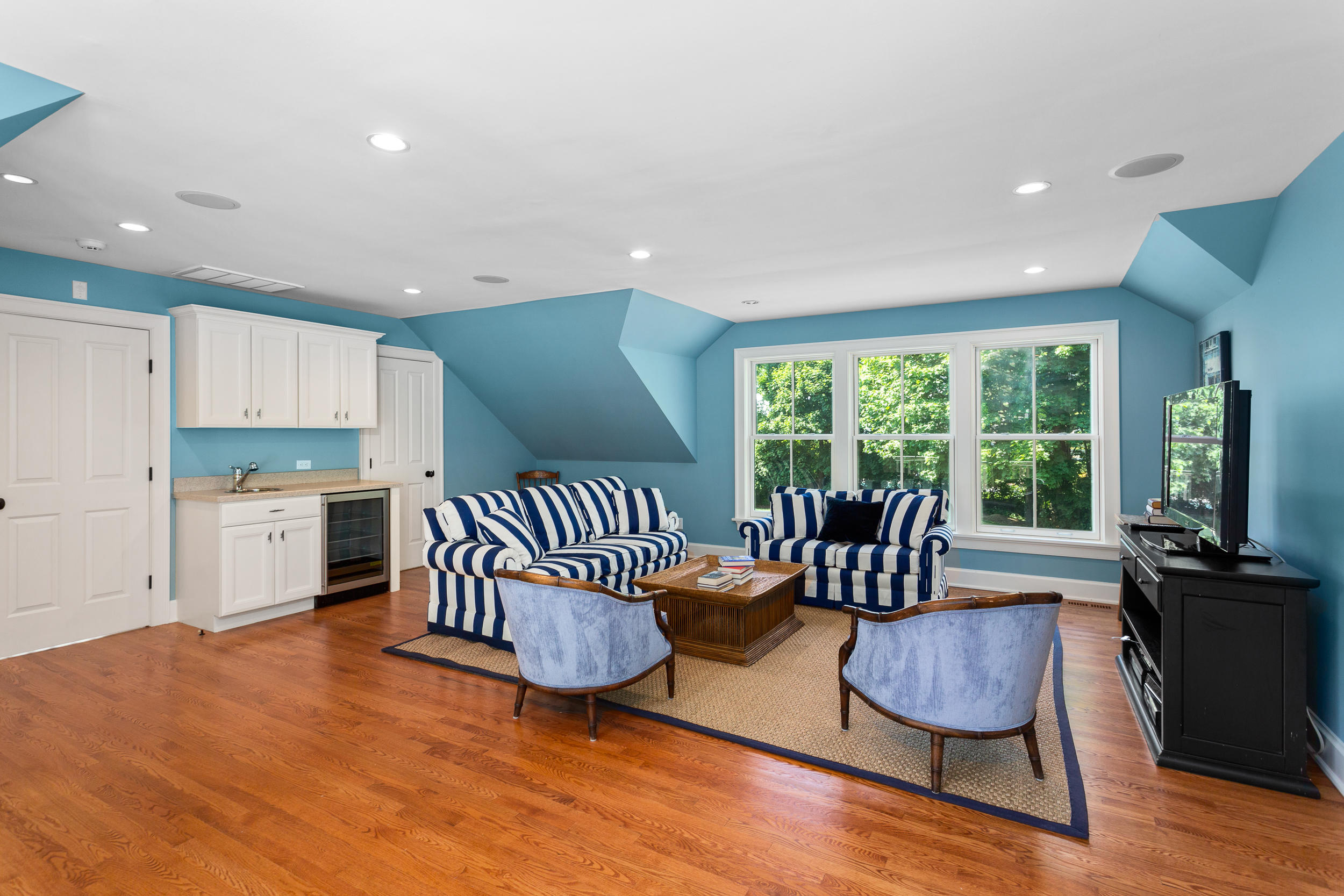 136 Pear Tree Point Road Darien, CT 06820 - Photo 39 of 56 a view of a dining room with furniture a chandelier and wooden floor