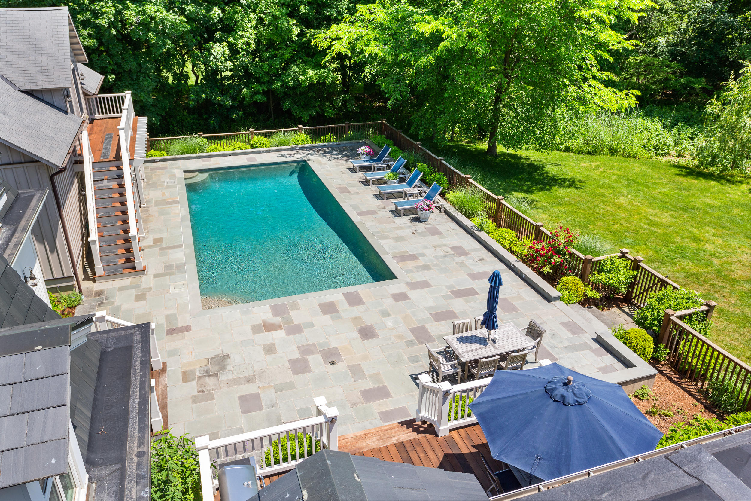 136 Pear Tree Point Road Darien, CT 06820 - Photo 48 of 56 a view of a balcony with two chairs and a fire pit
