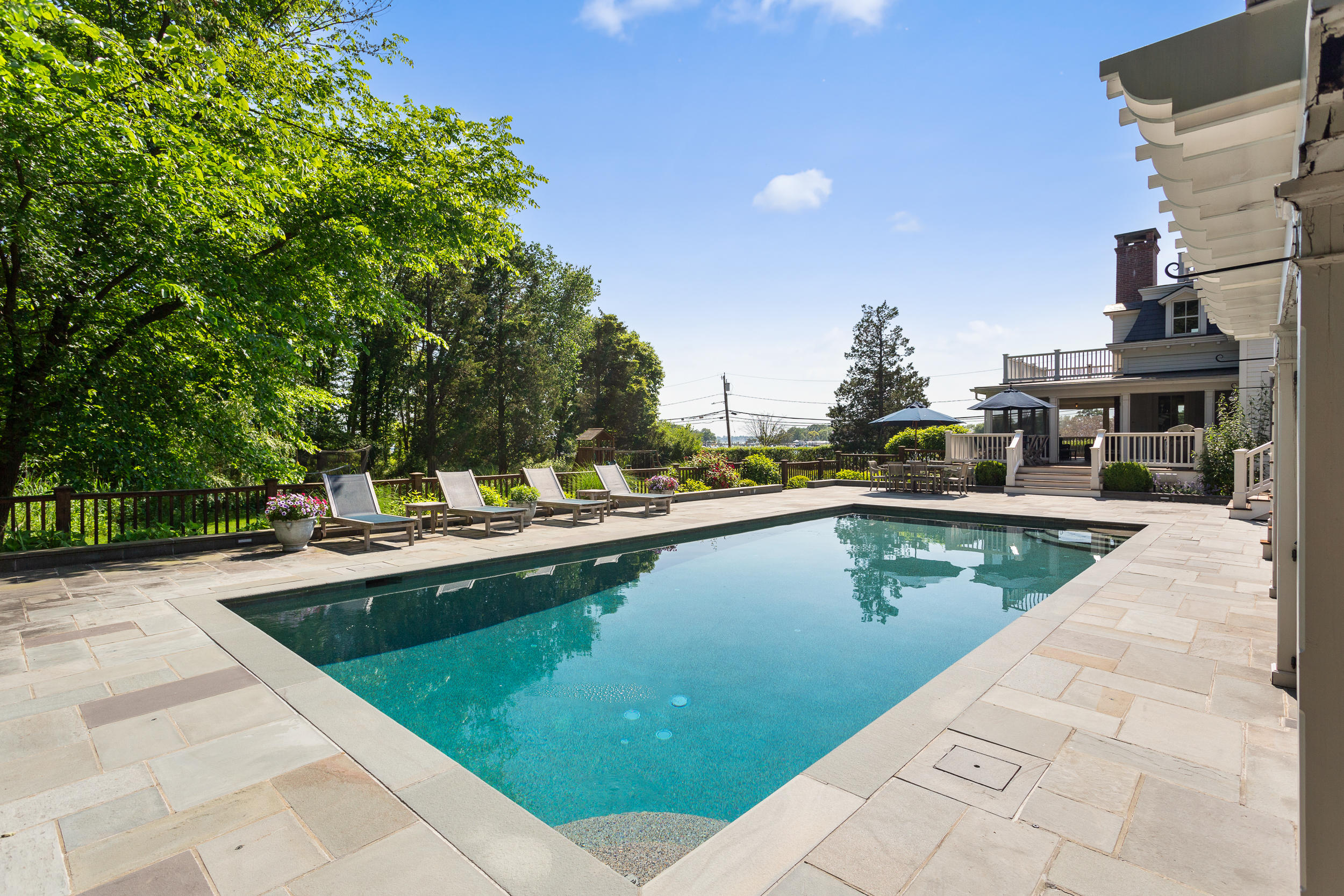136 Pear Tree Point Road Darien, CT 06820 - Photo 49 of 56 a view of swimming pool with outdoor seating and plants