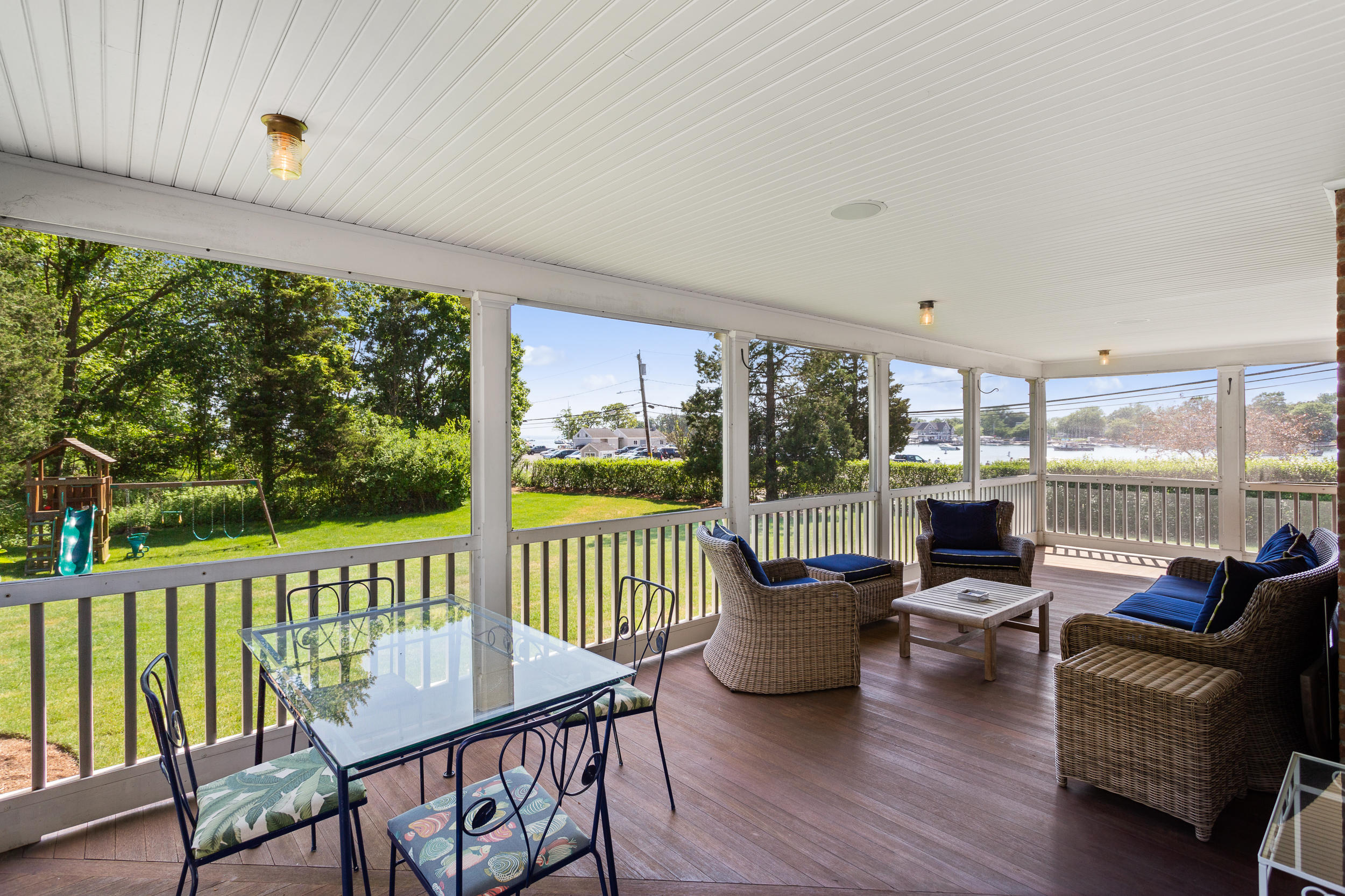 136 Pear Tree Point Road Darien, CT 06820 - Photo 52 of 56 a living room with furniture and a floor to ceiling window