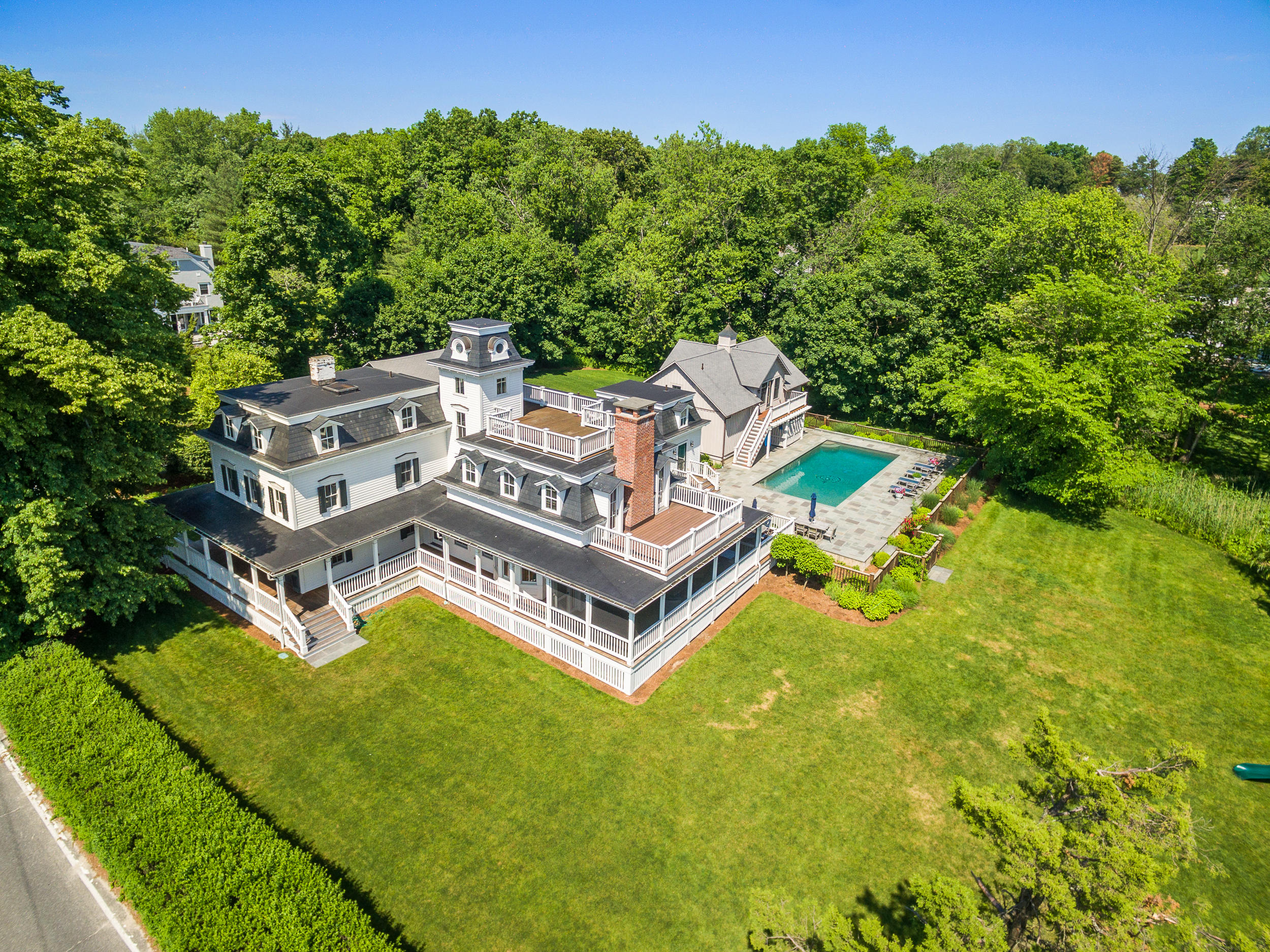 136 Pear Tree Point Road Darien, CT 06820 - Photo 6 of 56 an aerial view of a house with garden space and trees all around
