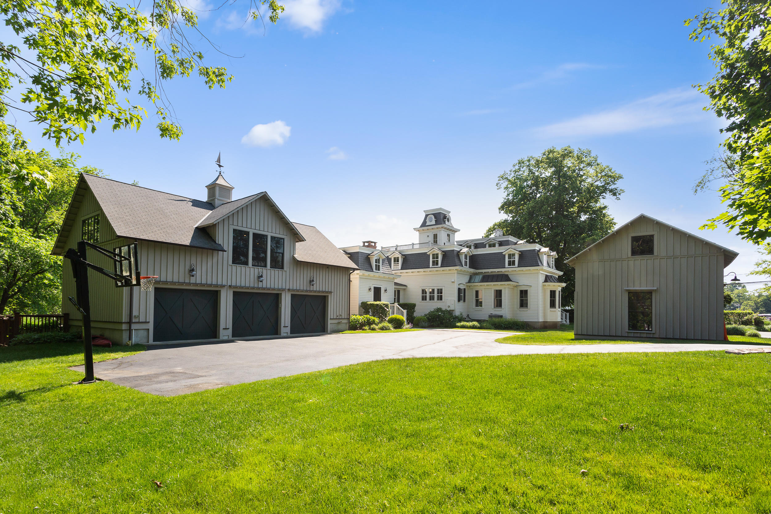 136 Pear Tree Point Road Darien, CT 06820 - Photo 7 of 56 a view of a house with a big yard and large trees