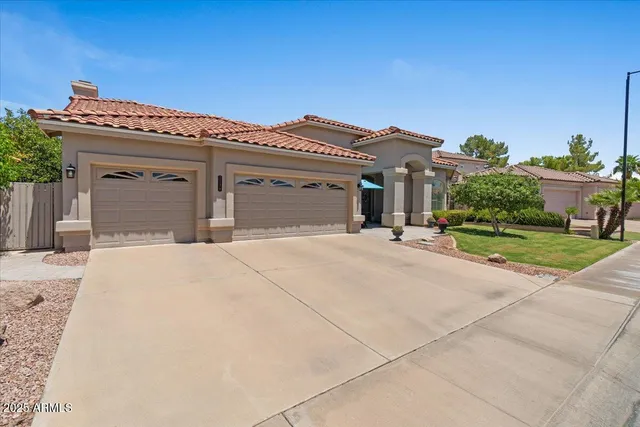 a view of a patio with couches chairs under an umbrella