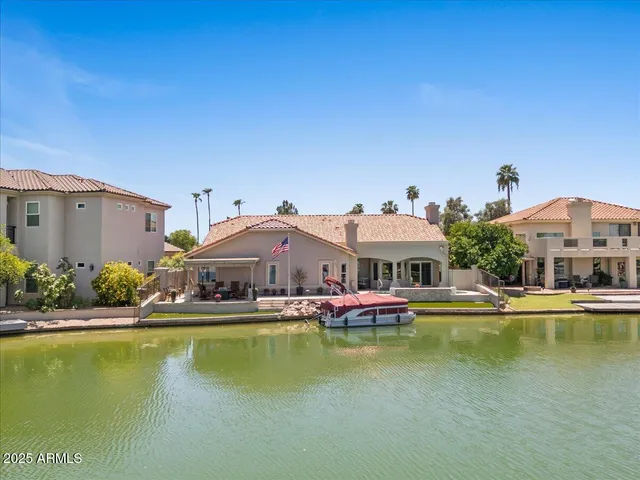 a aerial view of a house with swimming pool and lake view