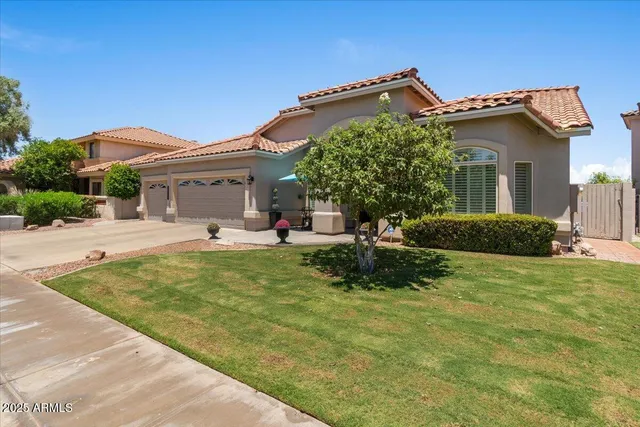 a living room with furniture a chandelier and a window