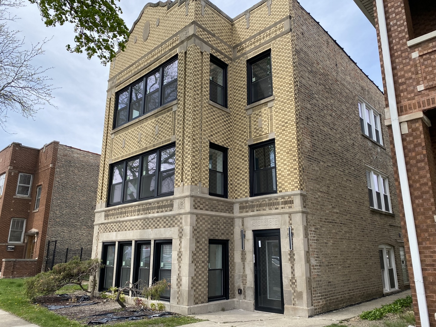 4352 West Augusta Boulevard, Unit 1 Chicago, IL 60651 - Photo 1 of 16 a front view of a brick building with many windows