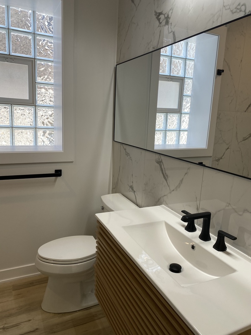 4352 West Augusta Boulevard, Unit 1 Chicago, IL 60651 - Photo 11 of 16 a bathroom with a sink a toilet and a window