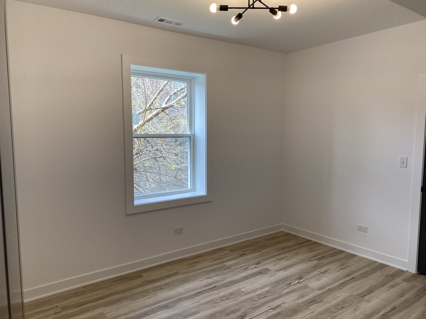 4352 West Augusta Boulevard, Unit 1 Chicago, IL 60651 - Photo 13 of 16 an empty room with a window