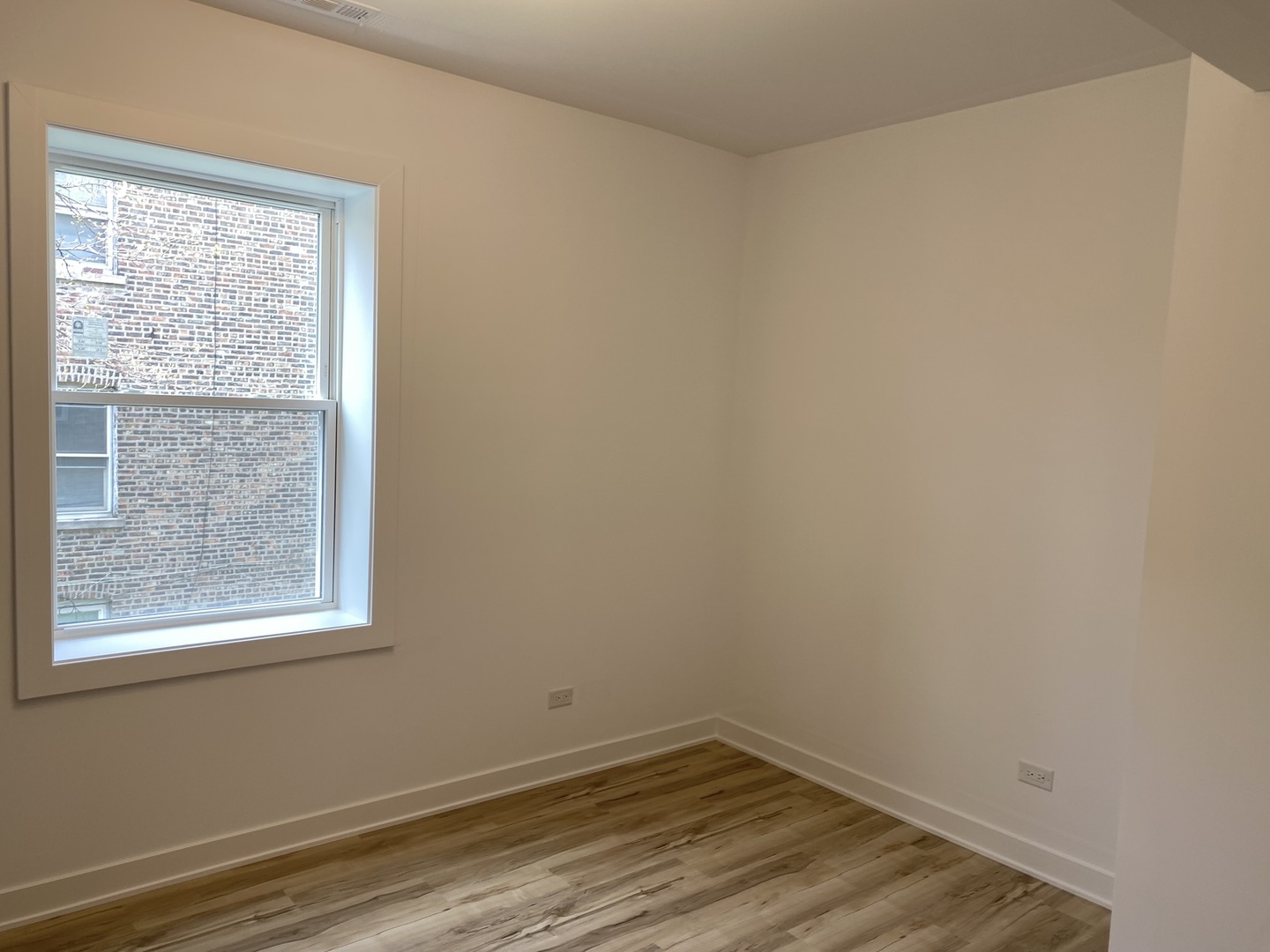 4352 West Augusta Boulevard, Unit 1 Chicago, IL 60651 - Photo 14 of 16 a view of a small space with wooden floor and a window