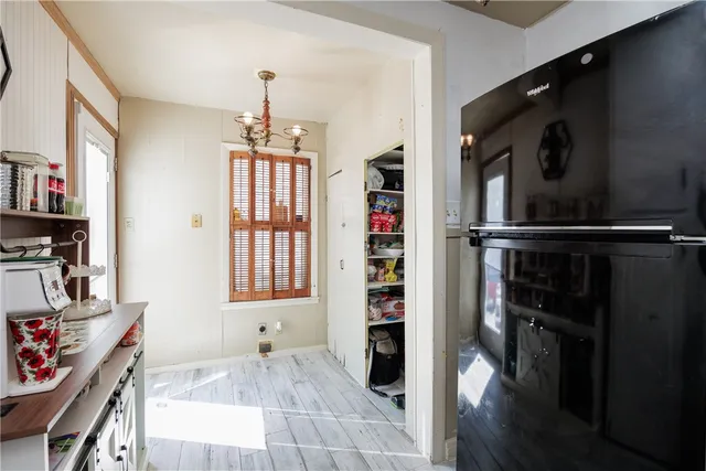 a hallway with front door wooden floor and windows