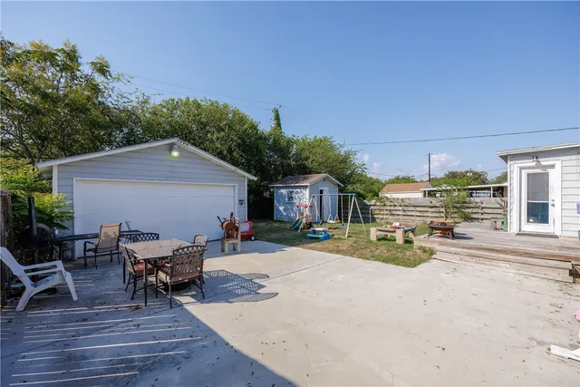 a view of a house with backyard porch and sitting area