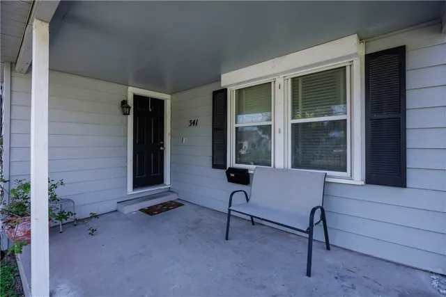 a living room with patio furniture and a window