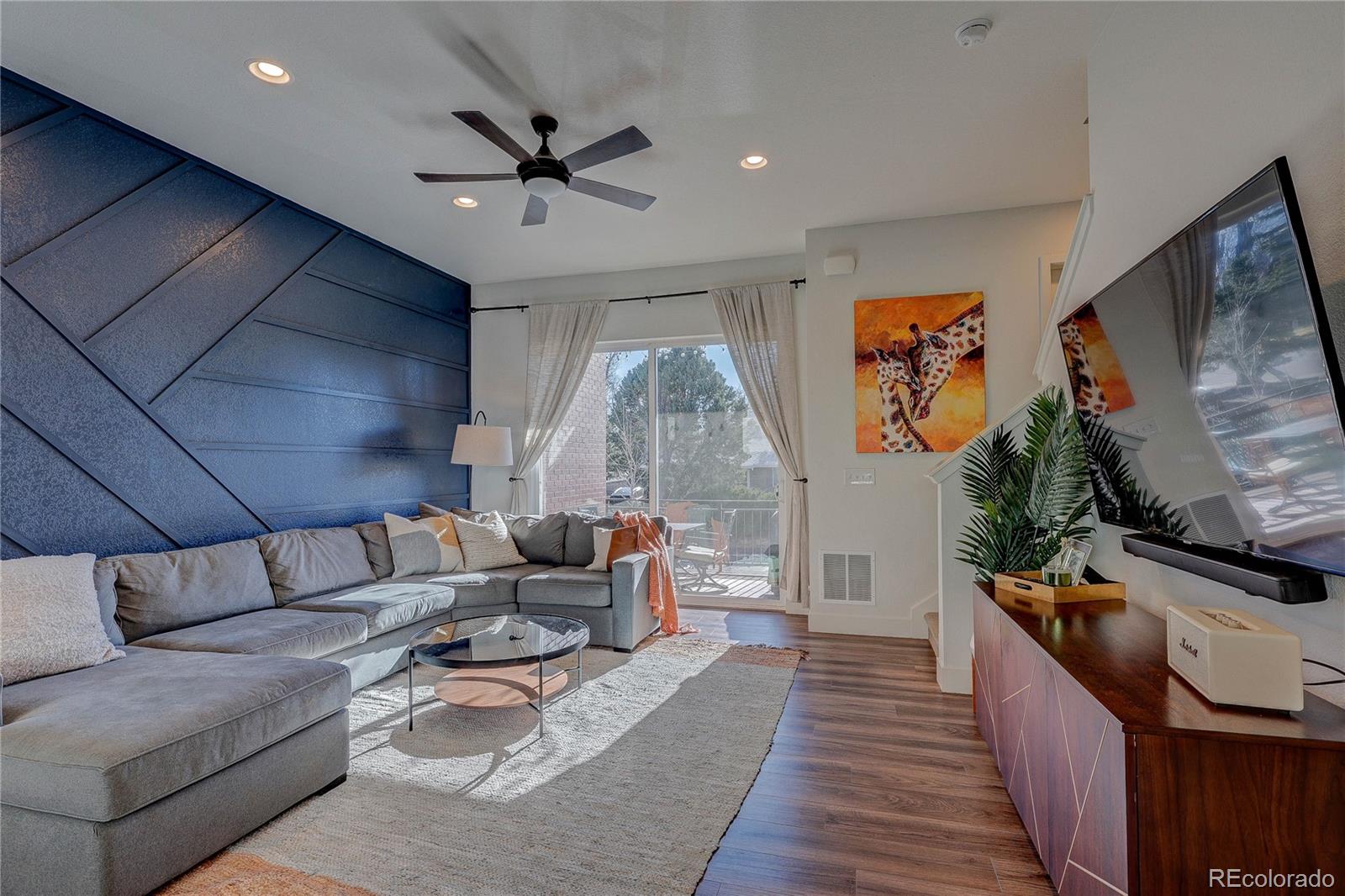 7825 West 42nd Avenue Wheat Ridge, CO 80033 - Photo 11 of 35 a living room with furniture and a flat screen tv