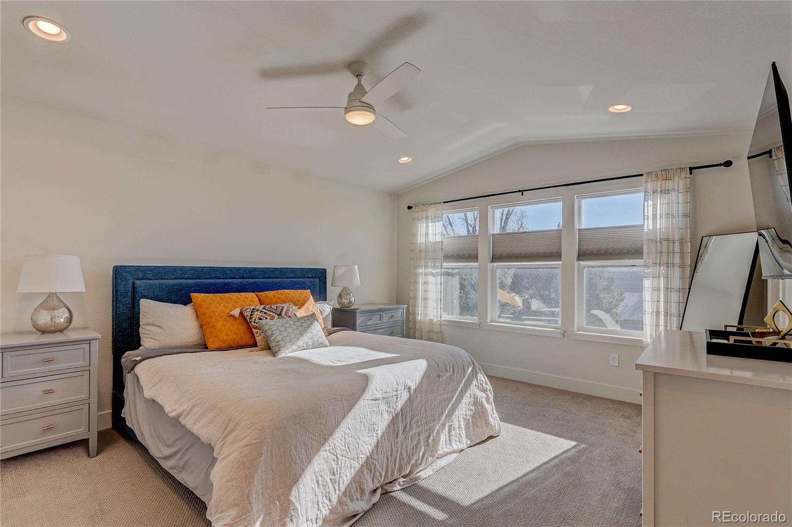 7825 West 42nd Avenue Wheat Ridge, CO 80033 - Photo 15 of 35 a bedroom with a large bed and a tv