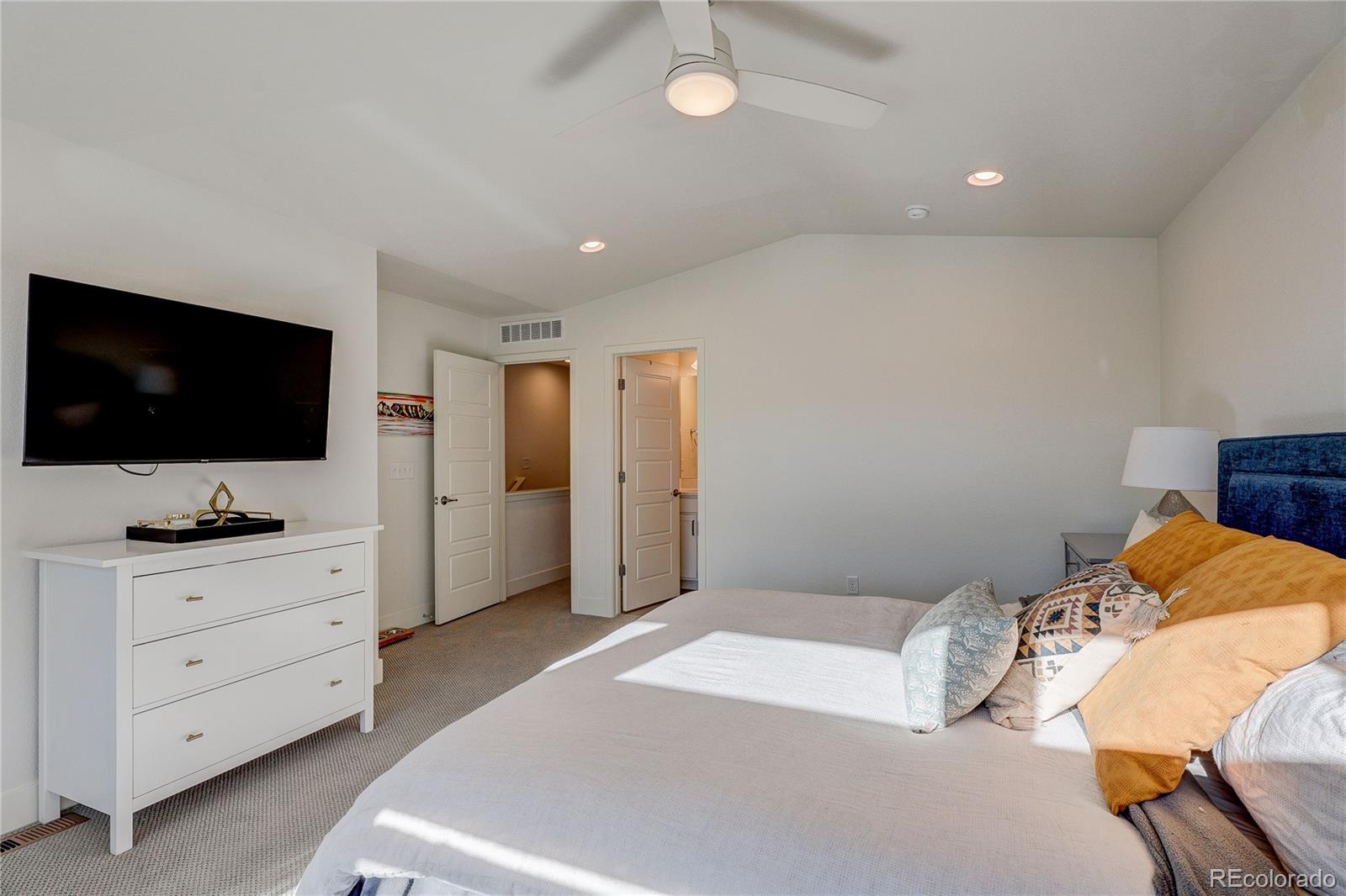 7825 West 42nd Avenue Wheat Ridge, CO 80033 - Photo 17 of 35 a bedroom with a bed and flat screen tv