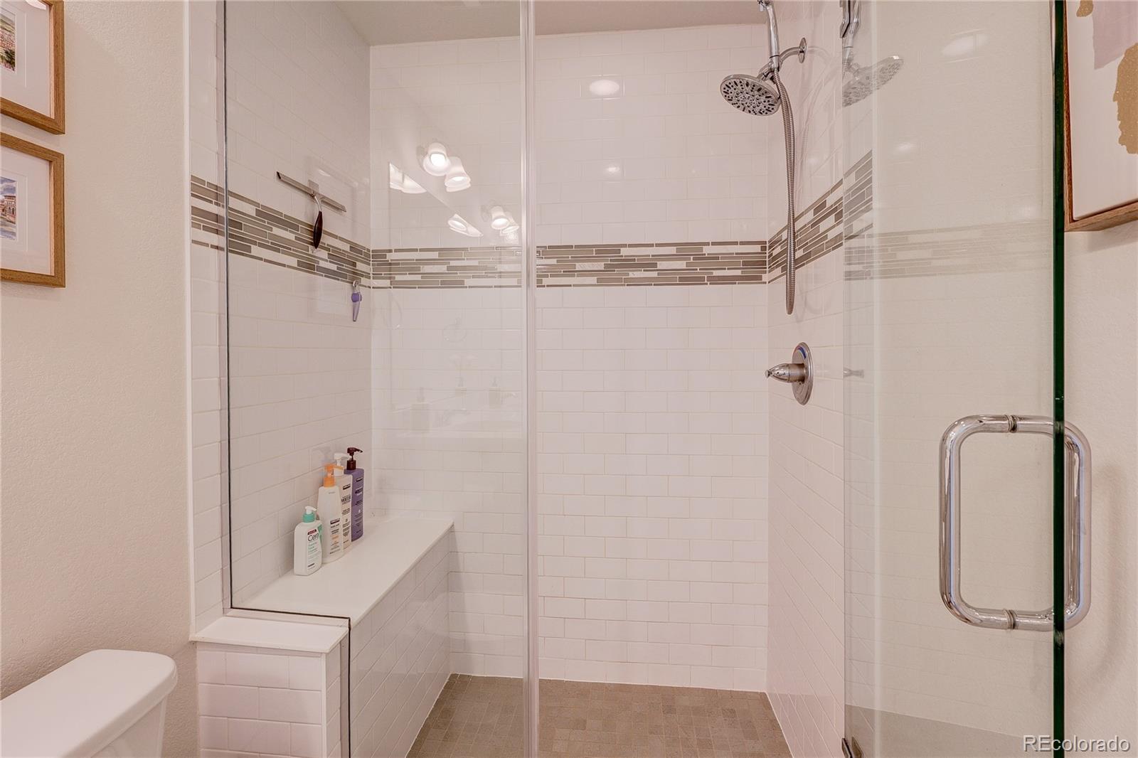 7825 West 42nd Avenue Wheat Ridge, CO 80033 - Photo 18 of 35 a bathroom with a shower a toilet and sink