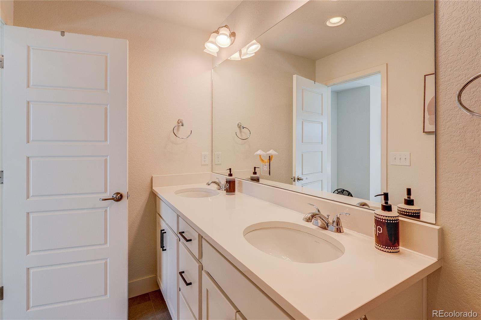 7825 West 42nd Avenue Wheat Ridge, CO 80033 - Photo 19 of 35 a bathroom with a sink vanity and a mirror