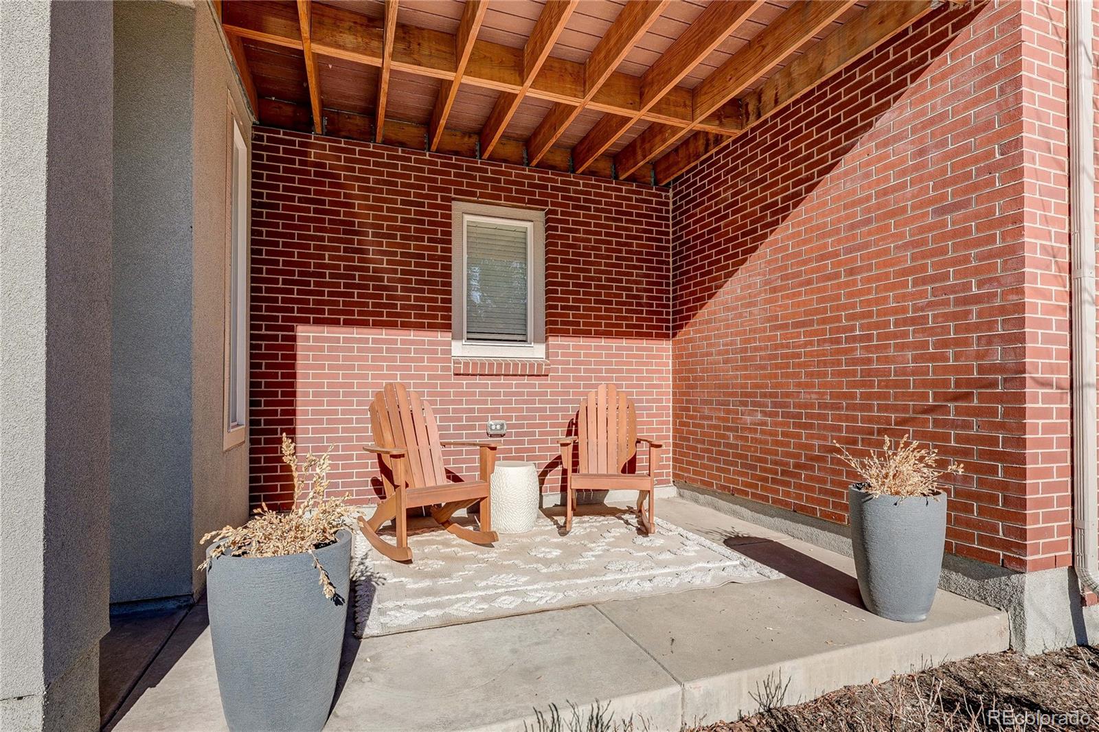 7825 West 42nd Avenue Wheat Ridge, CO 80033 - Photo 31 of 35 a view of a patio with couple of chairs and potted plants