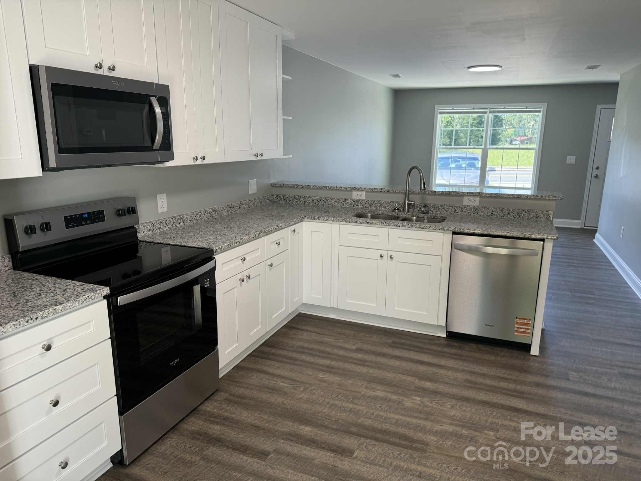 203 Linwood Road Lexington, NC 27292 - Photo 2 of 8 a kitchen with stainless steel appliances granite countertop a stove a sink and a microwave