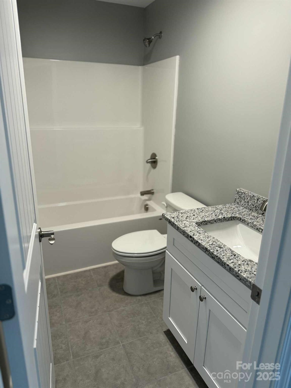 203 Linwood Road Lexington, NC 27292 - Photo 6 of 8 a bathroom with a granite countertop sink a toilet and shower