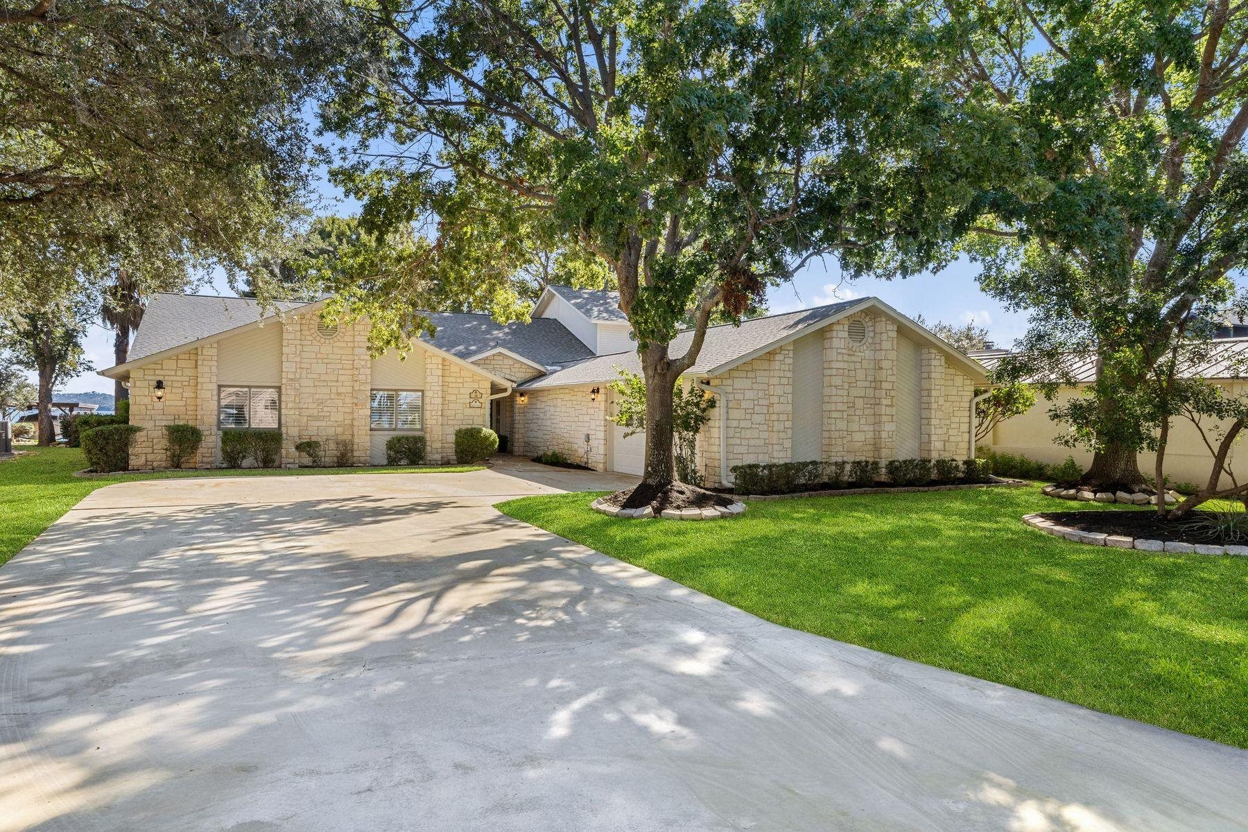 14 Beaver Island Road Granite Shoals, TX 78654 - Photo 12 of 30 a view of a yard in front of a house with plants and large tree