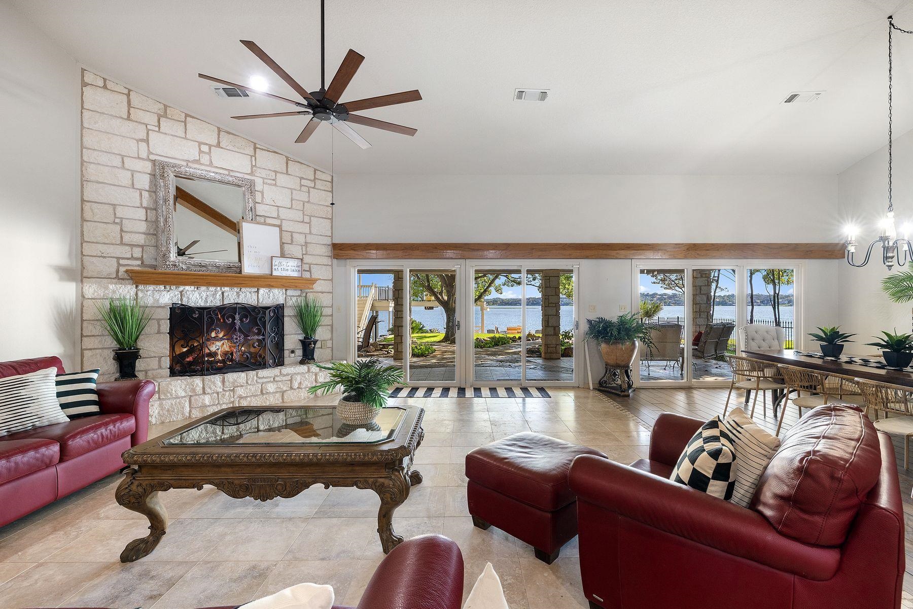 14 Beaver Island Road Granite Shoals, TX 78654 - Photo 14 of 30 a living room with furniture a fireplace and a large window
