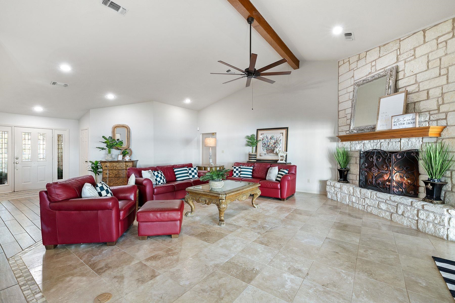 14 Beaver Island Road Granite Shoals, TX 78654 - Photo 17 of 30 a living room with furniture gym equipment and a fireplace