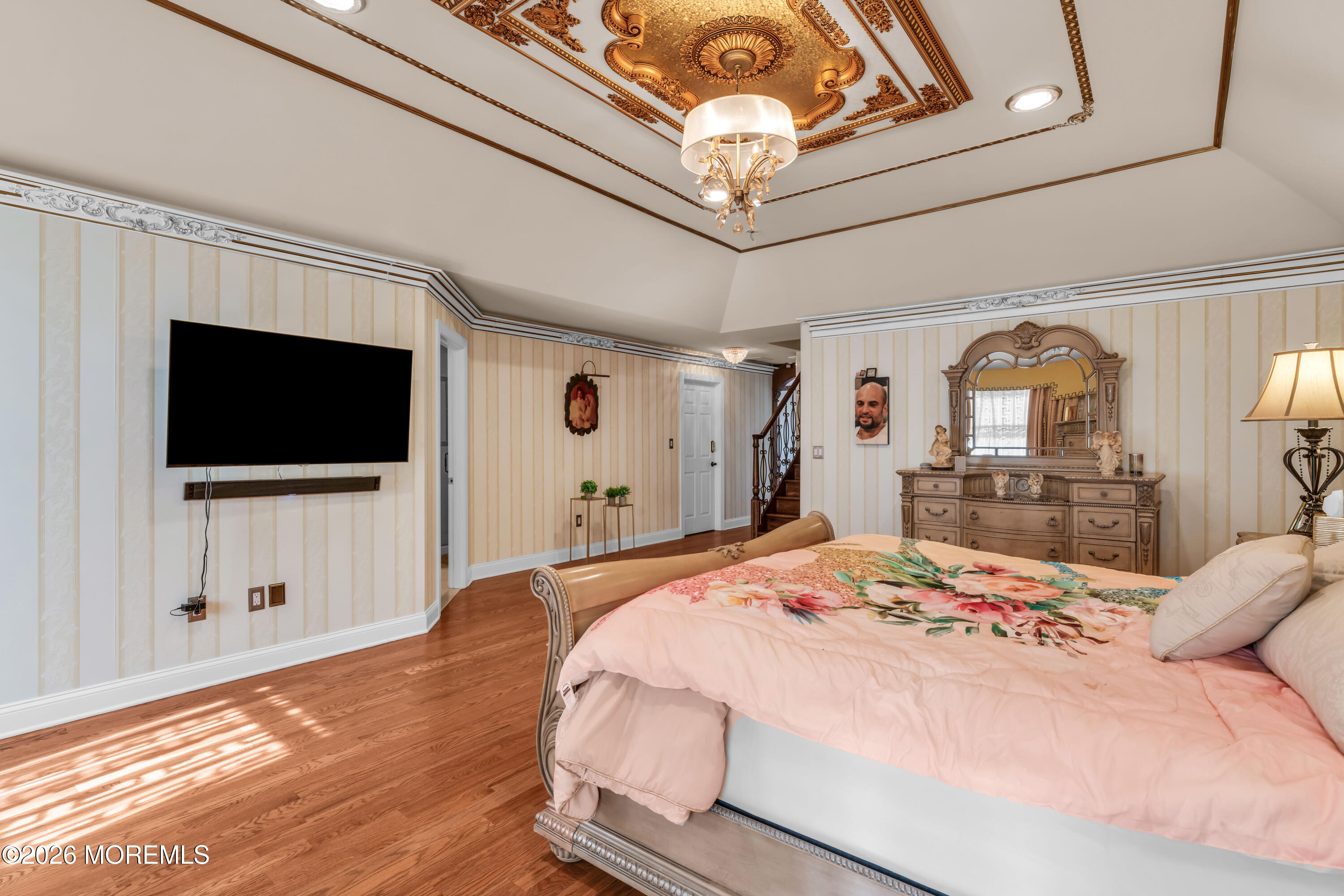 60 Yellow Meetinghouse Road Cream Ridge, NJ 08514 - Photo 38 of 59 a bedroom with a large bed a flat tv screen and a chandelier