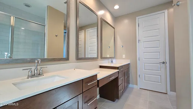 a bathroom with a sink double vanity and a mirror