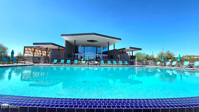 a view of swimming pool outdoor seating and city view