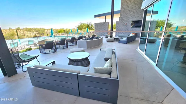 a living room with furniture a fireplace and a floor to ceiling window